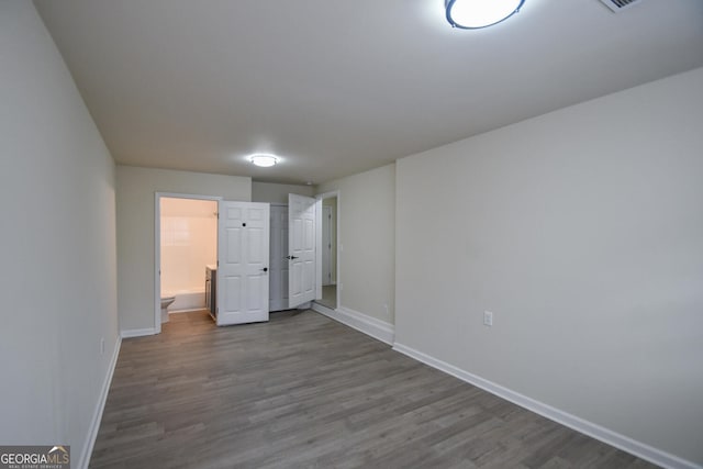 spare room featuring wood-type flooring