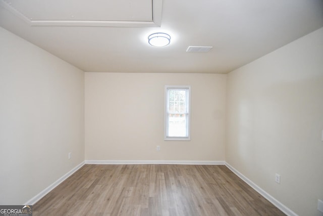 spare room featuring light hardwood / wood-style flooring