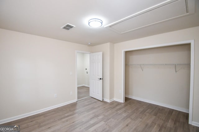 unfurnished bedroom with a closet and light wood-type flooring