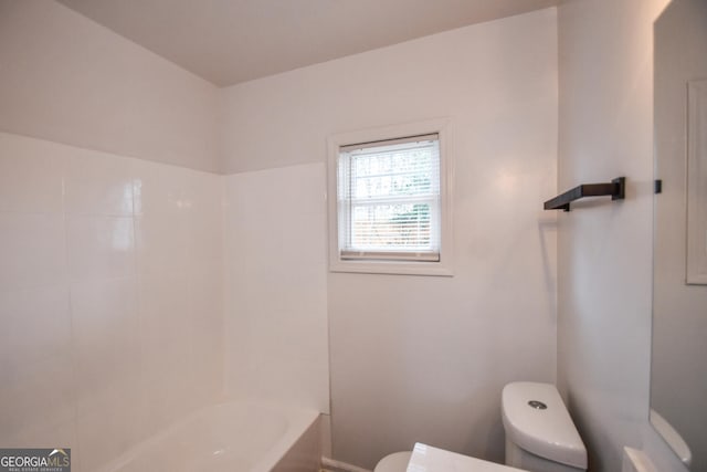 bathroom featuring washtub / shower combination and toilet