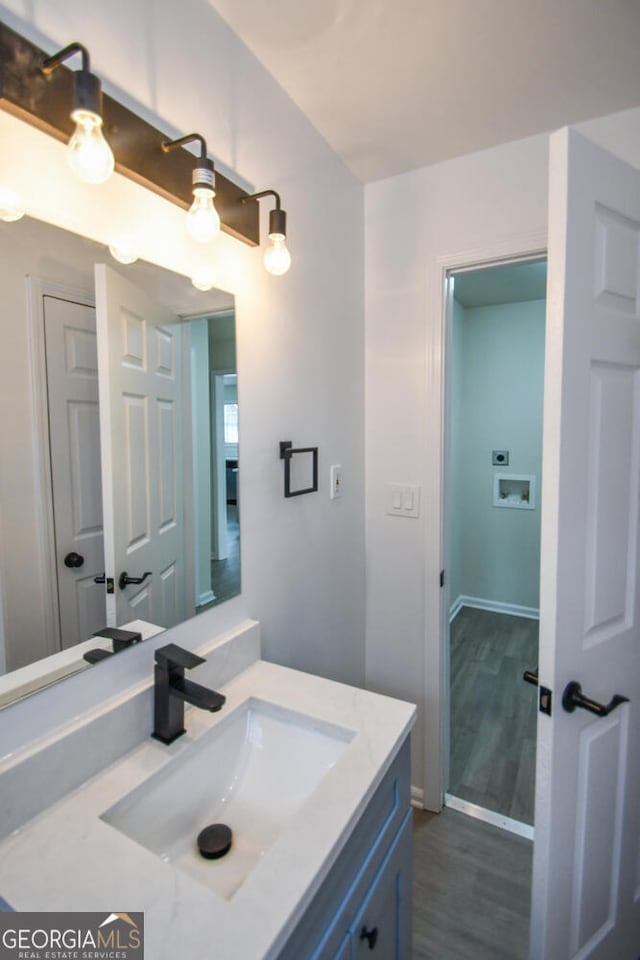 bathroom featuring vanity and wood-type flooring