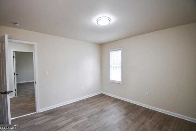 spare room with wood-type flooring