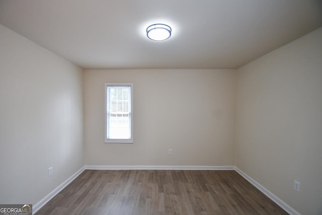 unfurnished room featuring wood-type flooring