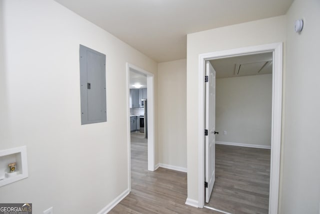 hall with hardwood / wood-style flooring and electric panel