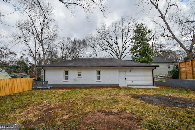 back of property featuring a lawn