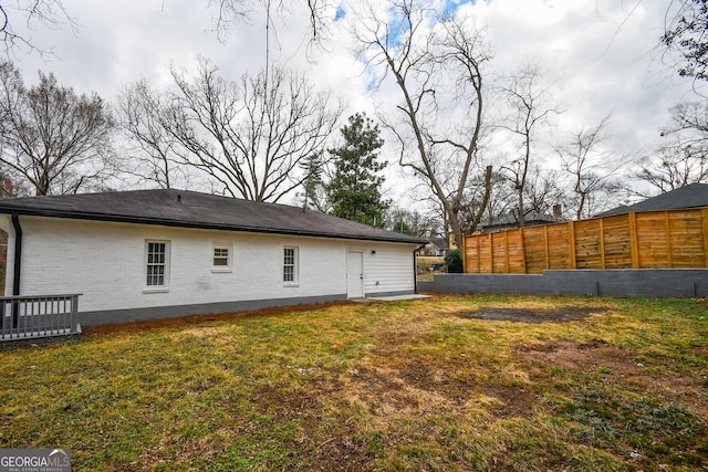 back of property featuring a yard