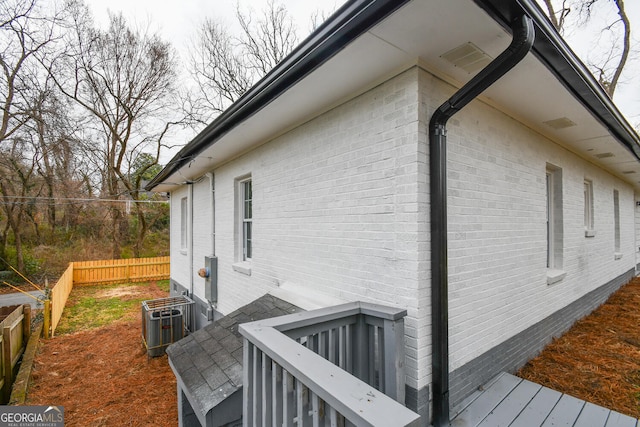 view of property exterior featuring central AC and a wooden deck