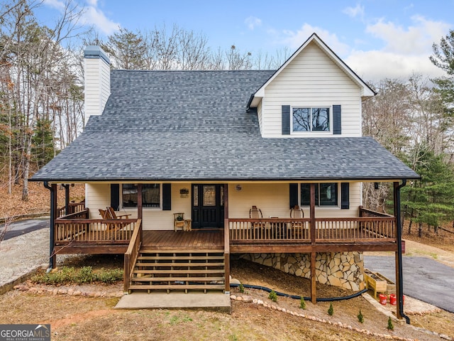 farmhouse-style home featuring a wooden deck