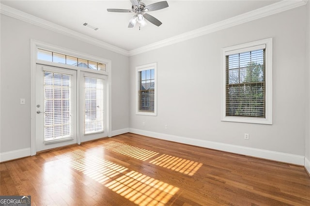 spare room with hardwood / wood-style flooring, ceiling fan, and ornamental molding