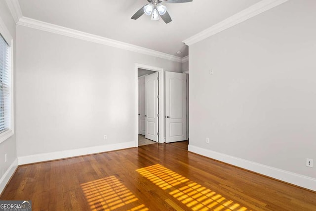 unfurnished bedroom with hardwood / wood-style flooring, ceiling fan, and crown molding