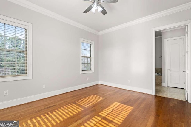 spare room featuring hardwood / wood-style floors, ornamental molding, and ceiling fan