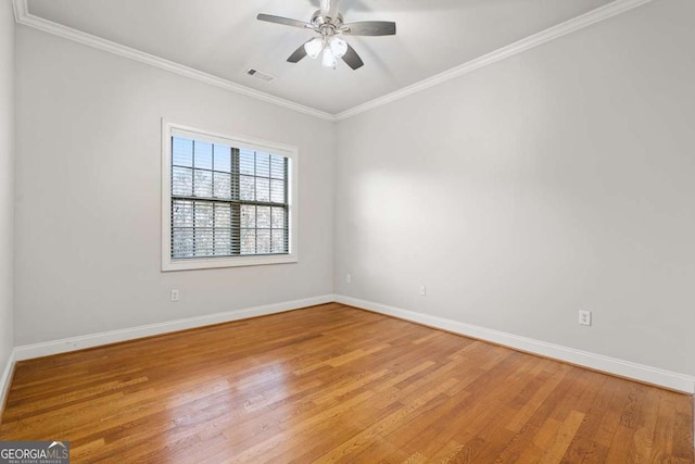 empty room featuring ornamental molding, ceiling fan, and light wood-type flooring