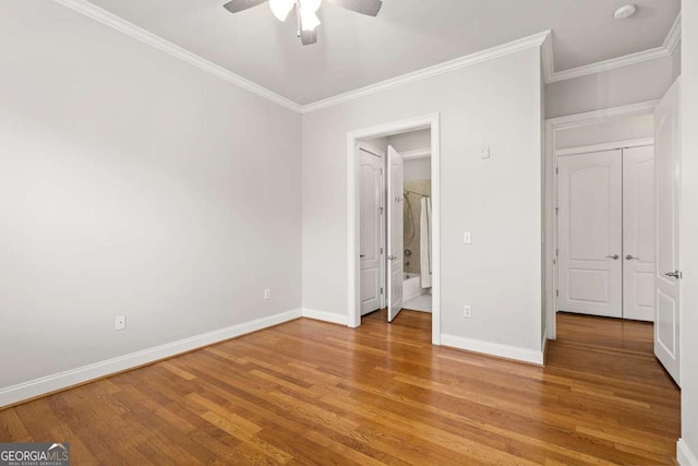 unfurnished bedroom featuring wood-type flooring, ornamental molding, and ceiling fan