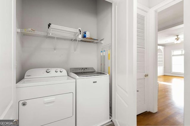 washroom featuring hardwood / wood-style floors, washer and dryer, and ceiling fan