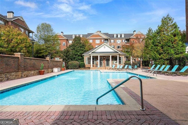 view of swimming pool featuring an outdoor structure and a patio area