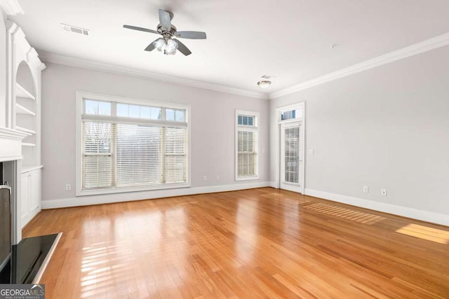 unfurnished living room with ornamental molding, ceiling fan, and light hardwood / wood-style flooring