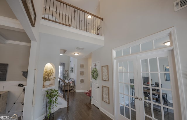 entryway featuring a high ceiling, french doors, visible vents, and dark wood-style flooring