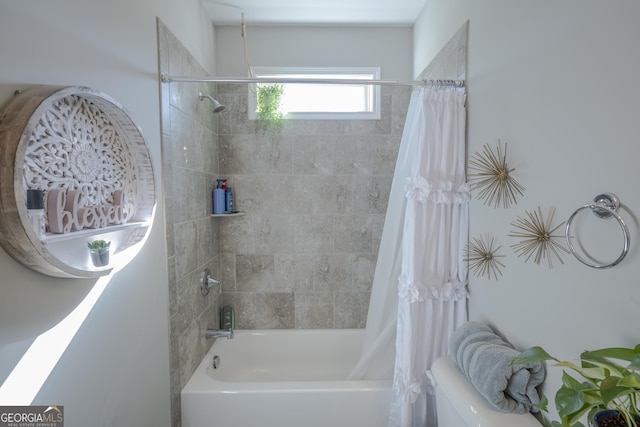 bathroom featuring toilet and shower / bath combo