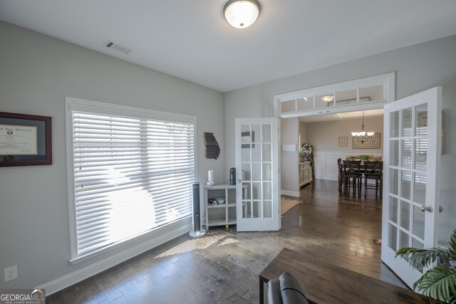 interior space featuring a chandelier, french doors, visible vents, and dark wood-style flooring