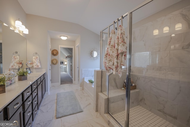 full bath featuring a stall shower, a garden tub, marble finish floor, vaulted ceiling, and vanity