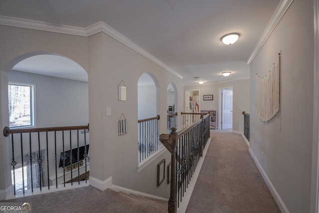 hall featuring light carpet, ornamental molding, an upstairs landing, and baseboards