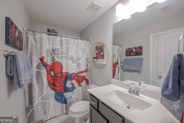 bathroom with toilet, visible vents, and vanity