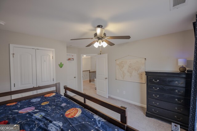 bedroom featuring carpet, a closet, visible vents, ceiling fan, and baseboards