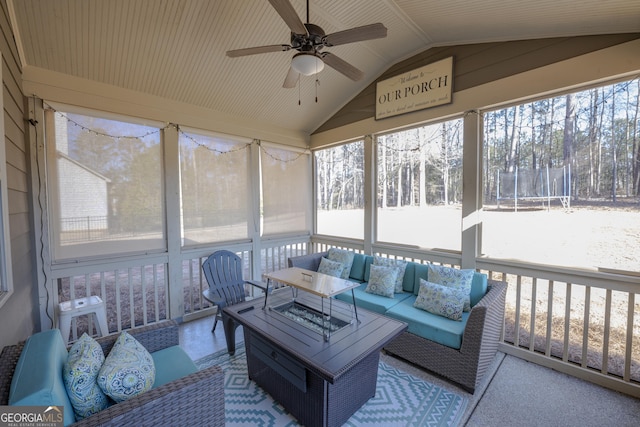 sunroom / solarium with plenty of natural light, vaulted ceiling, and ceiling fan