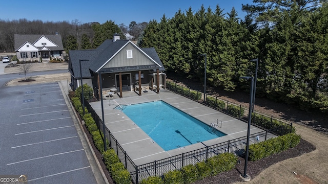 view of pool with a fenced in pool, a patio, and fence