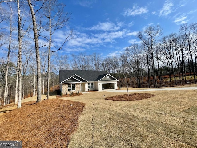 view of front of property featuring a garage and a front lawn