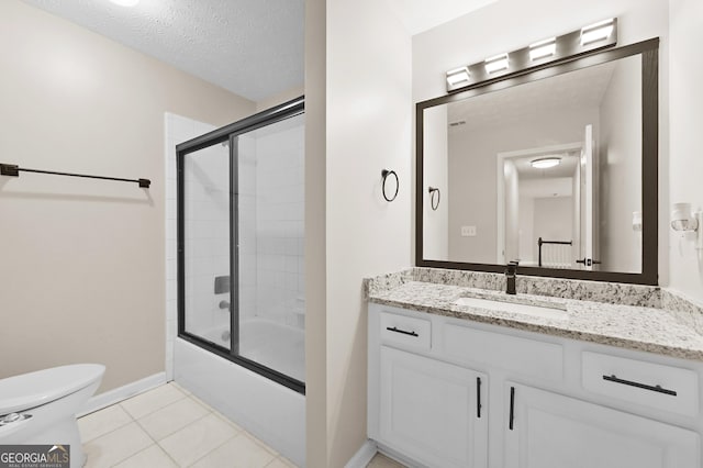 full bathroom with enclosed tub / shower combo, vanity, toilet, tile patterned floors, and a textured ceiling