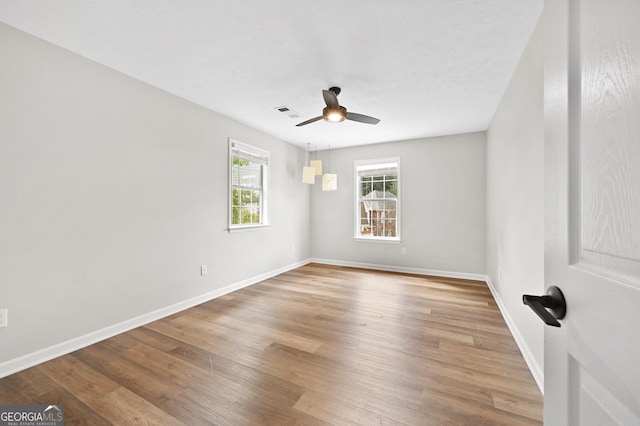 unfurnished room featuring wood-type flooring and ceiling fan