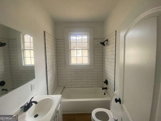 full bathroom featuring vanity, toilet, and tiled shower / bath