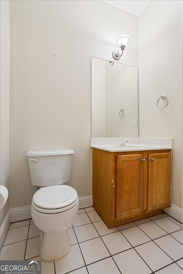 bathroom featuring vanity, tile patterned flooring, and toilet