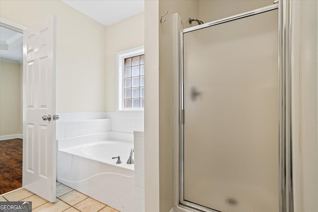 bathroom featuring ornamental molding, shower with separate bathtub, and tile patterned flooring