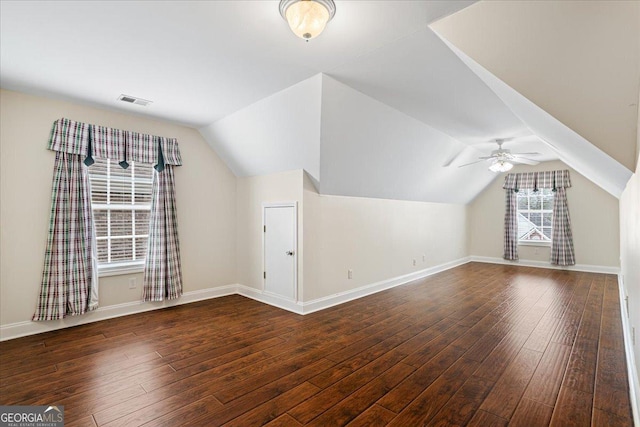 additional living space featuring ceiling fan, lofted ceiling, and dark hardwood / wood-style flooring