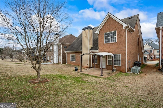 rear view of house with a patio and a lawn