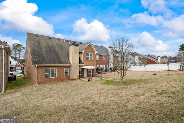 rear view of property with a patio, central AC unit, and a lawn