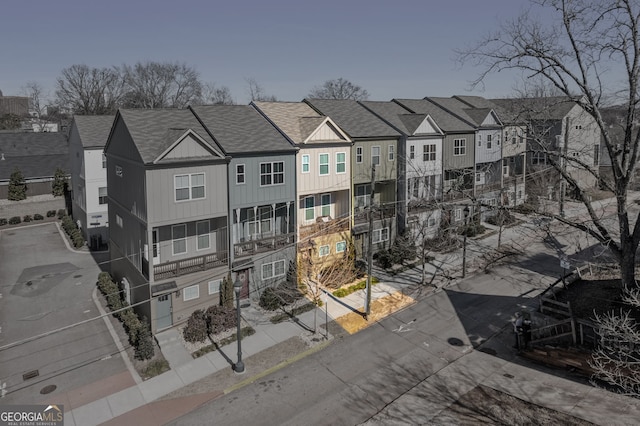 birds eye view of property with a residential view