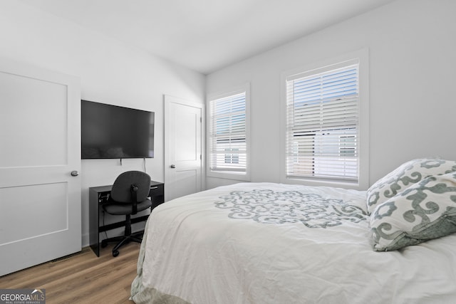 bedroom with a closet and wood finished floors