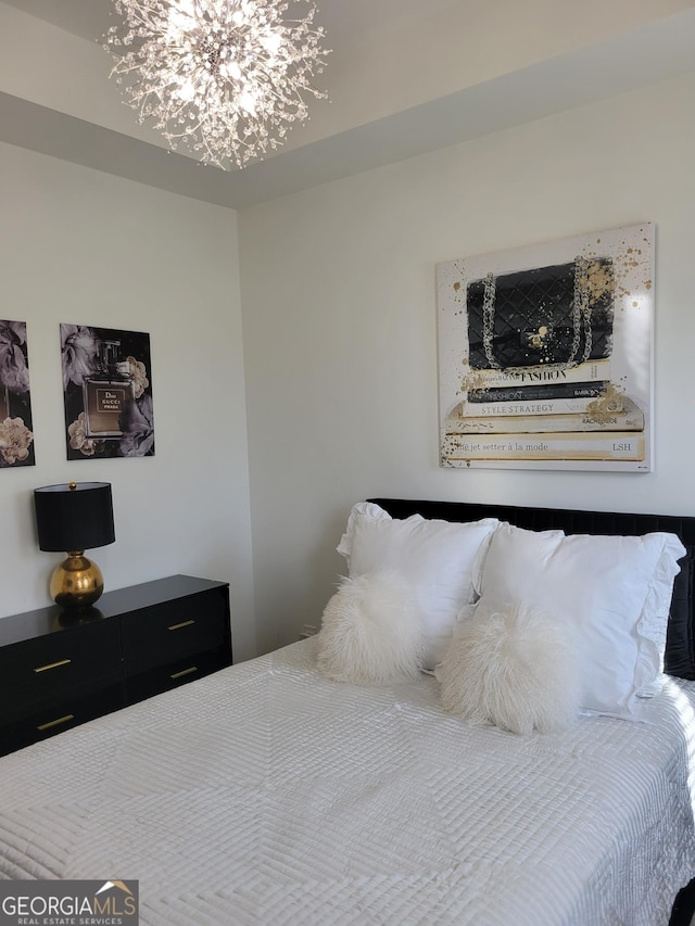 bedroom featuring an inviting chandelier