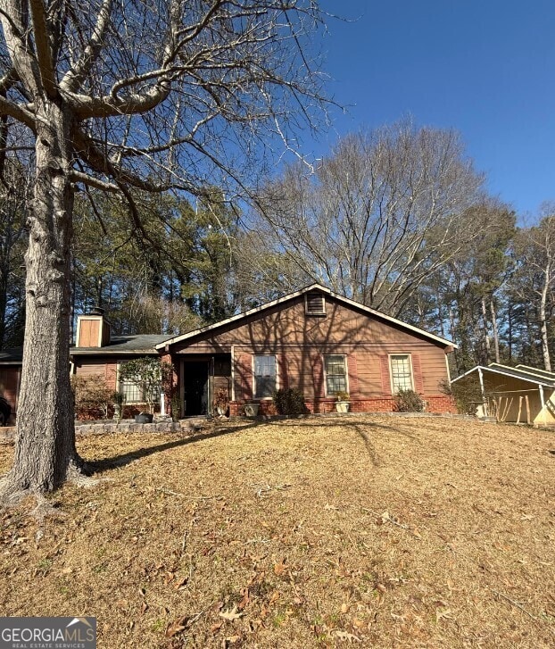 view of side of property with a yard