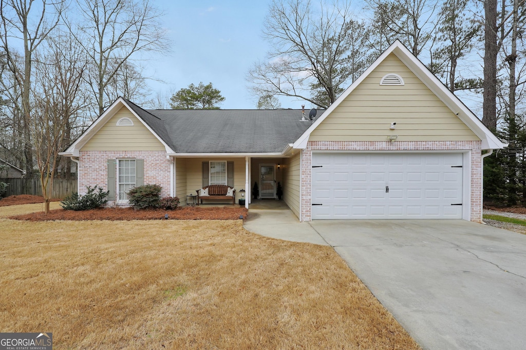 single story home with a garage and a front yard