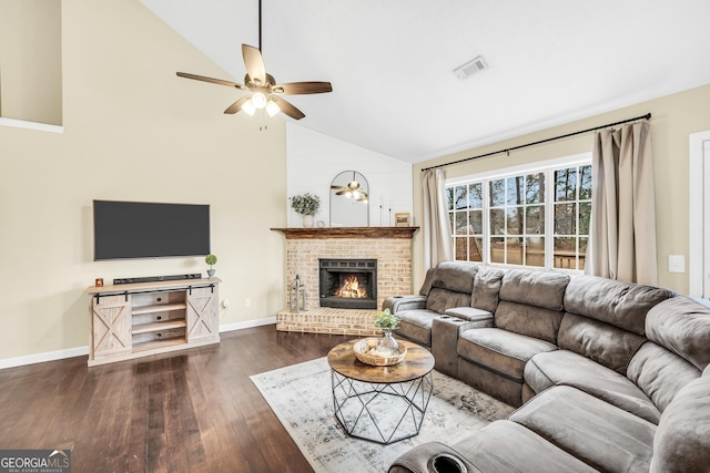 living room featuring dark hardwood / wood-style flooring, a fireplace, high vaulted ceiling, and ceiling fan