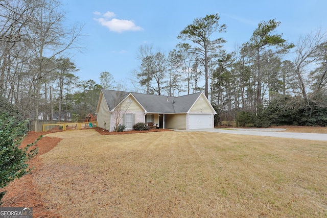 view of front facade featuring a garage, a front yard, and a playground