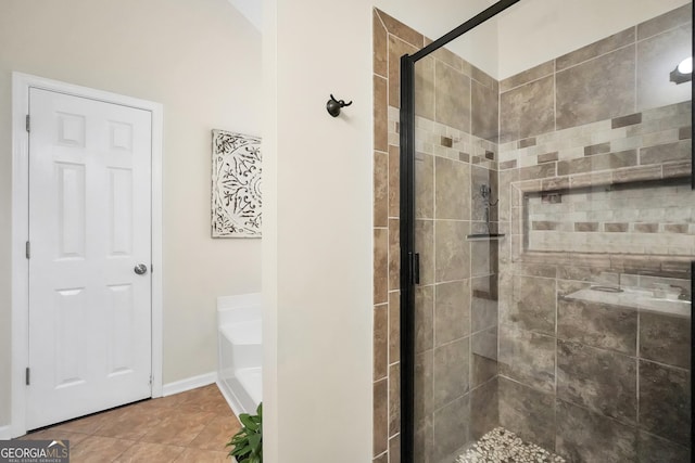 bathroom with an enclosed shower and tile patterned flooring