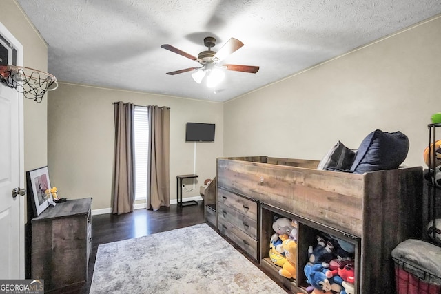 bedroom featuring ceiling fan, dark hardwood / wood-style flooring, and a textured ceiling