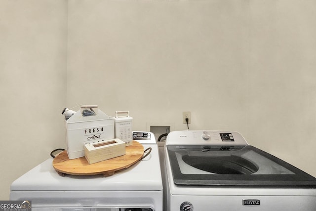 clothes washing area with independent washer and dryer