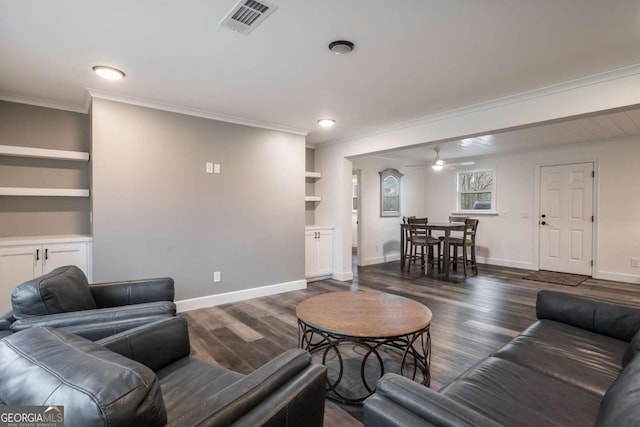 living room with crown molding, ceiling fan, dark hardwood / wood-style flooring, and built in shelves