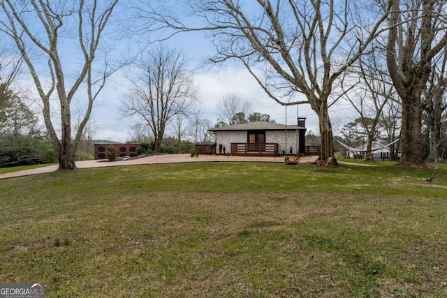 view of front of home with a front lawn and a deck